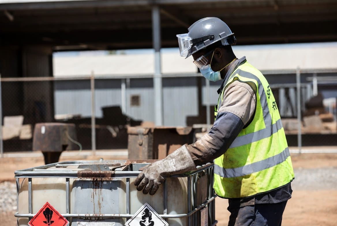 South African worker preparing hazardous trash for safe collection and disposal